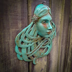 Art Nouveau inspired sculpture of beautiful female face with long stylised hair