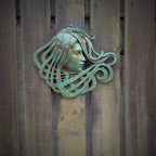 Art Nouveau inspired sculpture of beautiful female face with long stylised hair